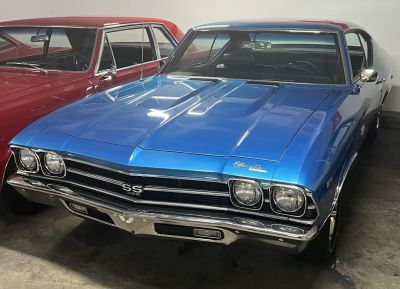 Classic muscle car front with dual headlights and chrome bumper