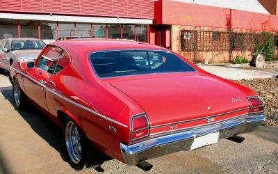 Classic red vintage muscle car rear with SS badge and chrome bumper