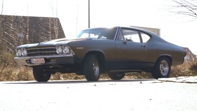 Front grille and side profile of a classic sport coupe muscle car.