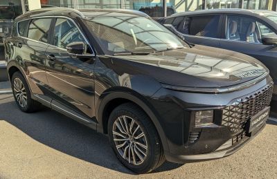 Modern front design and multi-spoke alloy wheels on a black SUV