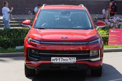 Front view of a red SUV with sleek headlights and modern grille