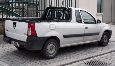 Rear side view of pickup with truck bed and steel wheels