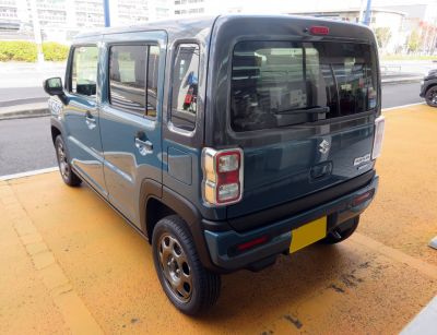 Rear view of boxy compact SUV with distinctive taillights and rear window wiper