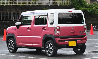 Rear side view of a compact SUV with boxy shape and dual-tone paint