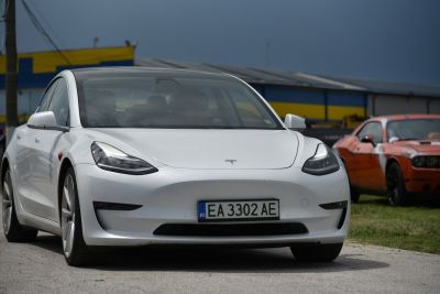 Front view of white electric sedan with LED headlights and aerodynamic shape