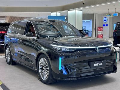 Futuristic LED headlights with vertical daytime running lights on a sleek black long-wheelbase SUV
