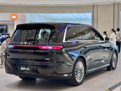 Rear view with continuous LED taillight strip and alloy wheels