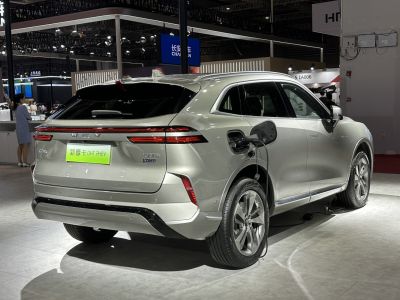 Rear side of electric SUV with open charging port and sleek taillights