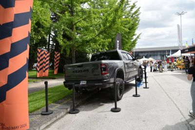 Lifted off-road pickup rear with black rims and rugged tires