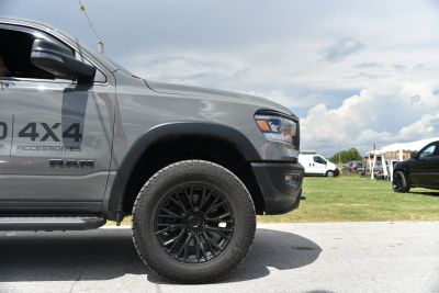 Close-up of pickup truck front side with black alloy wheel and headlight