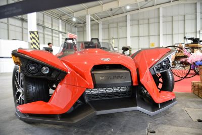 Angular headlights and aerodynamic front of a three-wheeled sport vehicle.