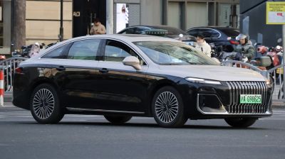 Sleek sedan with vertical grille and multi-spoke alloy wheels