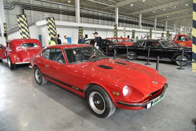 Red 280Z 2+2 sports coupe with front hood vents and classic wheel rims