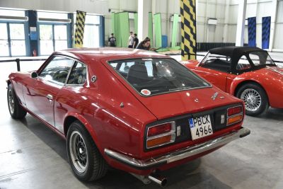 Red classic 1976 280Z 2+2 rear view with distinct taillights and wheels