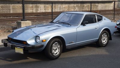 Vintage coupe with pop-up round headlights and sleek alloy wheels