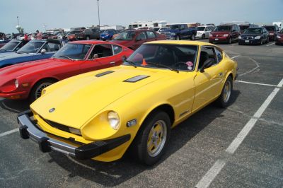Yellow vintage sports coupe with hood vents and black bumper