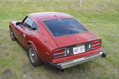 Fastback coupe rear side view with alloy wheels and tinted rear window