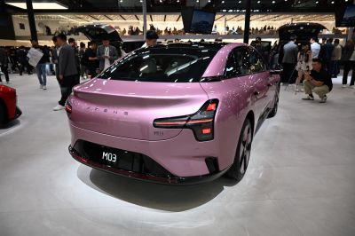 Rear view of a sleek electric sedan with distinct taillights and smooth body lines
