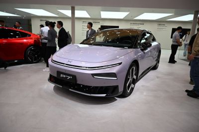Front view of futuristic electric sedan with sleek LED lights and aerodynamic styling