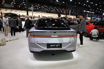 Sleek rear view with continuous LED tail light strip and smooth modern design.