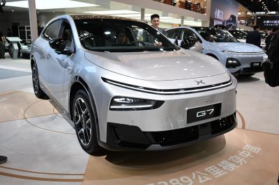 Sleek front view of an electric SUV with LED daytime running lights and aerodynamic features.