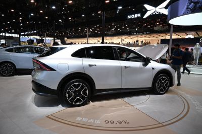 Sleek side profile with aerodynamic design and black alloy wheels.