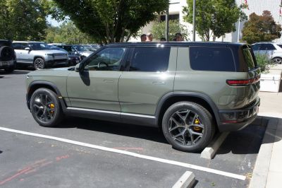 Side view of electric SUV with black roof and yellow brake calipers