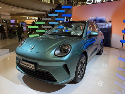 Futuristic EV front with round headlights and sleek metallic paint