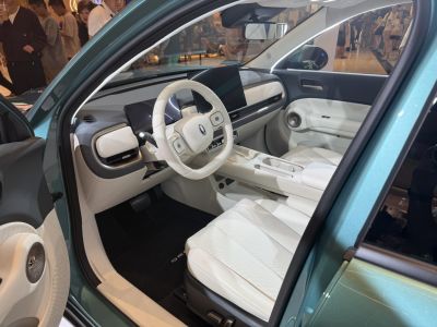 Modern car interior with digital dashboard and white leather seats