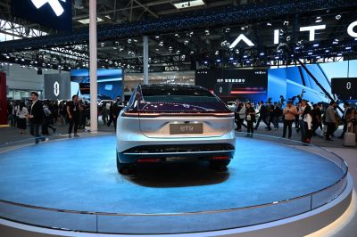 Rear view of a luxury electric sedan with sleek tail lights and smooth design