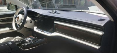 Digital display with wood trim and luxury steering wheel