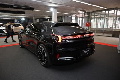 Rear view of a sleek modern electric hatchback with distinctive LED taillights.