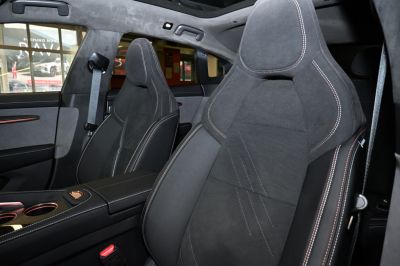 Premium sport-style front seats with detailed stitching and suede upholstery