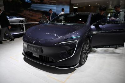 Futuristic front aerodynamic design with distinct headlights and open driver door