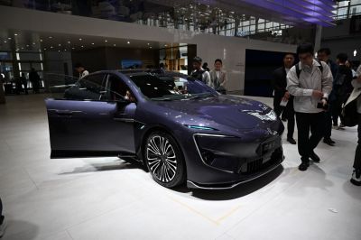 Futuristic LED headlights and open driver door.