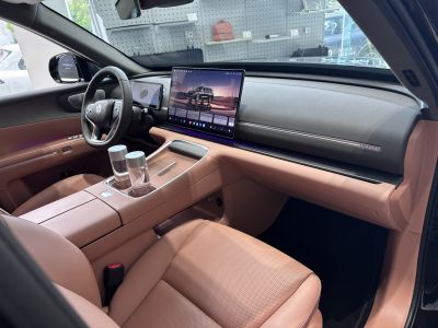 Dual digital screens and beige leather interior with modern dashboard