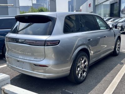 Rear-side view of a modern SUV with sleek taillights and chrome multi-spoke wheels