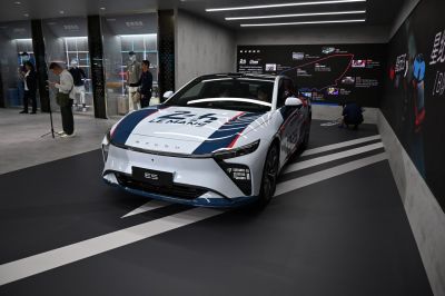 Electric sedan with Le Mans racing livery and distinctive LED headlights