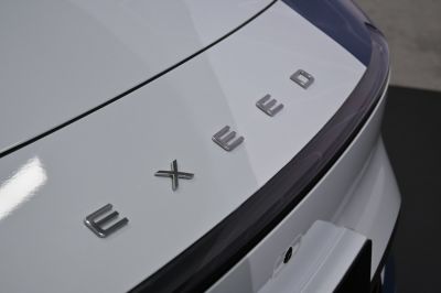 Close-up of rear badge and trunk detail on white surface