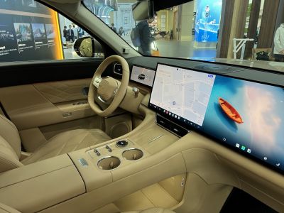 Beige leather interior with dual widescreen digital displays and advanced controls