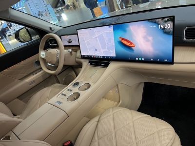 Beige leather interior with dual panoramic digital screens and modern controls