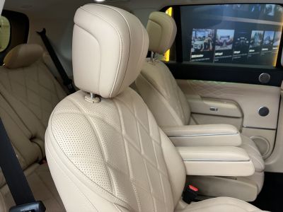 Beige perforated leather seats with armrests in spacious cabin