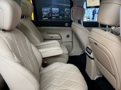 Beige leather rear seats with diamond pattern and foldable armrest