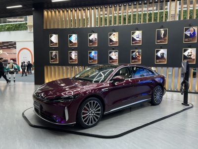 Sleek sedan with LED headlights and alloy wheels showcased indoors