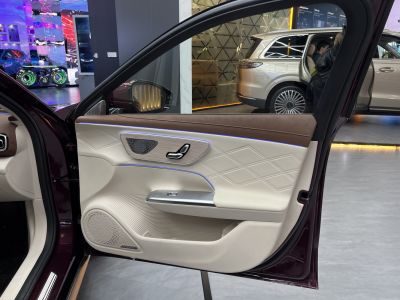 Quilted leather car door interior with ambient lighting and advanced controls