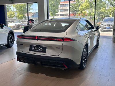 Rear view with continuous LED tail light bar and aerodynamic styling