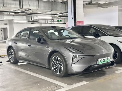 Modern electric sedan with futuristic LED headlights and aerodynamic design