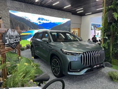 SUV with vertical grille and LED headlights in nature-themed showroom