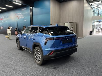 Rear and side view of a blue SUV with sharp taillights and aerodynamic styling
