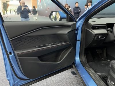 Driver door panel with window and side mirror controls in modern design